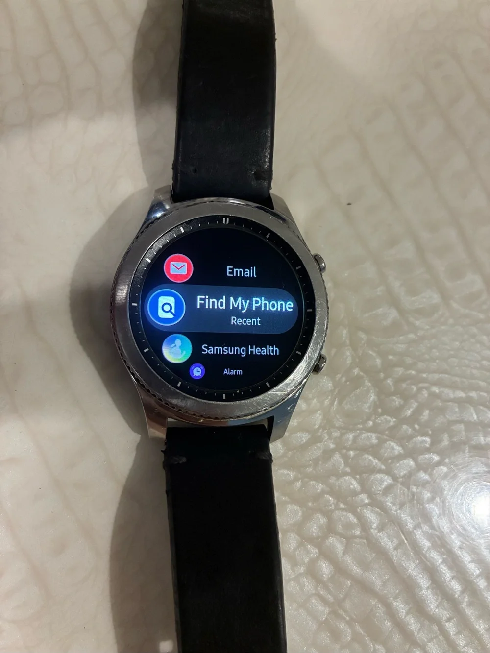 Samsung Silver Smartwatch with Black Strap and Blue Display